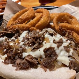 Philly steak with cheese, fried onions, and onion rings