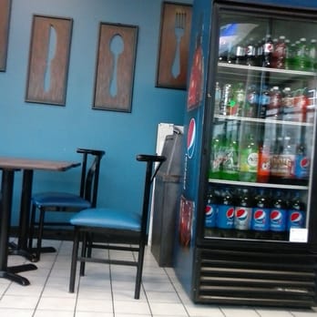Benito's Pizza Troy - a table and chairs in front of a vending machine - Pizza Near Me - Troy, Michigan Benito's Pizza Troy - a table and chairs in front of a vending machine - Pizza Near Me - Troy, Michigan
