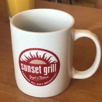 Sunset Grill - a white coffee mug on a wooden table - Breakfast & Brunch Near Me - Burlington, Ontario