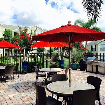 Ashton Chase - Plenty of poolside tables as well as a gas grill allows residents to have a cookout with friends and family. - Apartments Near Me - Clermont, Florida