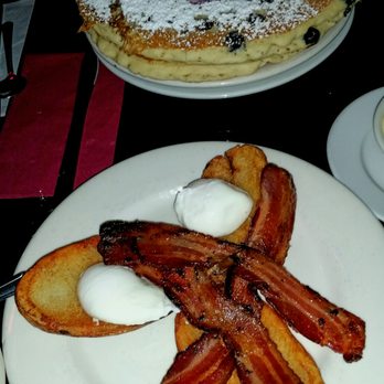 The Griddle Cafe - Poached y Papas- Benedict with Bacon and two poached eggs atop seasoned potato skins. Covered in our incredible Hollandaise sauce. - Breakfast & Brunch Near Me - Los Angeles, California The Griddle Cafe - Poached y Papas- Benedict with Bacon and two poached eggs atop seasoned potato skins. Covered in our incredible Hollandaise sauce. - Breakfast & Brunch Near Me - Los Angeles, California