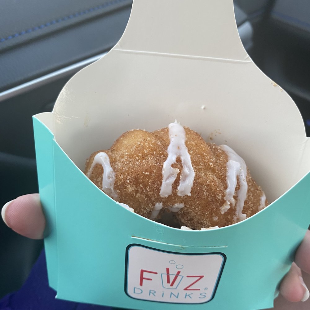 FiiZ Drinks - a person holding a donut in a box - Desserts Near Me - Sandy, Utah FiiZ Drinks - a person holding a donut in a box - Desserts Near Me - Sandy, Utah