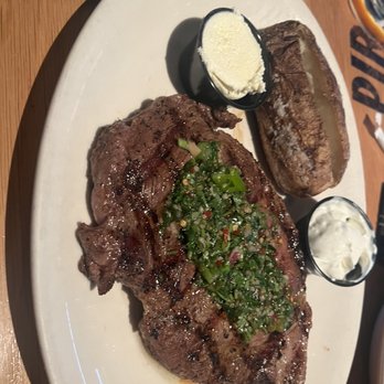 BJ's Restaurant & Brewhouse - BJ's Classic Rib-Eye* medium rare w chimchuri - New American Near Me - Avon, Indiana BJ's Restaurant & Brewhouse - BJ's Classic Rib-Eye* medium rare w chimchuri - New American Near Me - Avon, Indiana