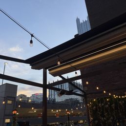Roof cover retracted on a beautiful summer evening on the roof patio Roof cover retracted on a beautiful summer evening on the roof patio
