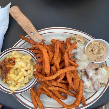 The Lake House - Smothered chicken dinner with sweet potato fries (cinnamon honey butter) and Mac and cheese - Seafood Near Me - Santee, South Carolina The Lake House - Smothered chicken dinner with sweet potato fries (cinnamon honey butter) and Mac and cheese - Seafood Near Me - Santee, South Carolina