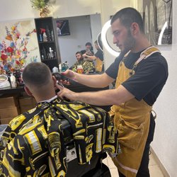 Roberts Haircuts and Shaves - The barber cutting up a a client. He can cut all types of hair from straight to curly.