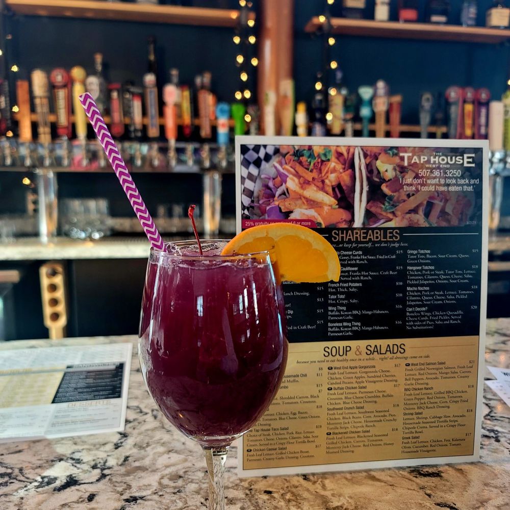 a glass of wine and a menu a glass of wine and a menu