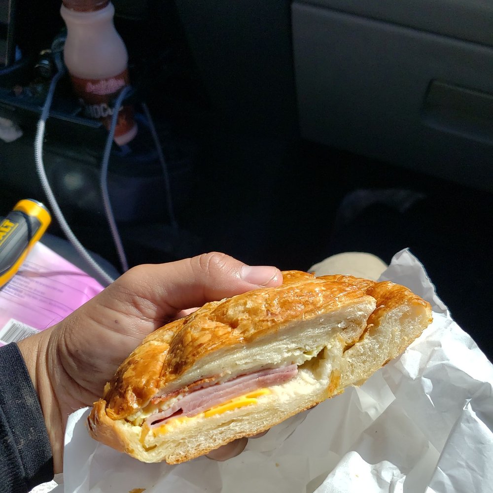 a person holding a sandwich