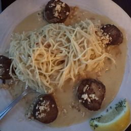 Scallops with angel hair pasta covered in a roasted garlic sauce. Scallops with angel hair pasta covered in a roasted garlic sauce.