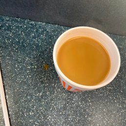 a cup of coffee on a counter a cup of coffee on a counter