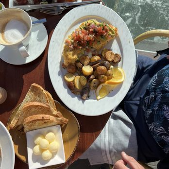 Schooners Monterey - Seafood omelette, sourdough toast with an over abundance of better and a latte. - Seafood Near Me - Monterey, California Schooners Monterey - Seafood omelette, sourdough toast with an over abundance of better and a latte. - Seafood Near Me - Monterey, California
