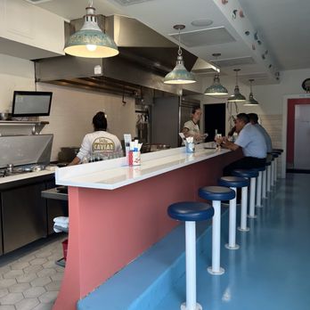 Garbos - a man sitting at a counter in a restaurant - Seafood Near Me - Austin, Texas Garbos - a man sitting at a counter in a restaurant - Seafood Near Me - Austin, Texas