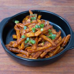 MoMo Bros - Fries Chilli: Crispy fries tossed in a spicy, tangy sauce in Nepali-style seasonings. A bold and flavorful twist on classic fries