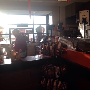 Dunkin' -  a woman behind a counter in a coffee shop - Donuts Near Me - Hamilton, New Jersey