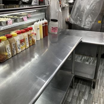 St Ann's Fish Market - a stainless steel counter with a variety of condiments - Seafood Near Me - Bronx, New York St Ann's Fish Market - a stainless steel counter with a variety of condiments - Seafood Near Me - Bronx, New York