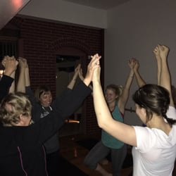 Laura Solly Yoga - Family yoga supporting one another in tree pose!