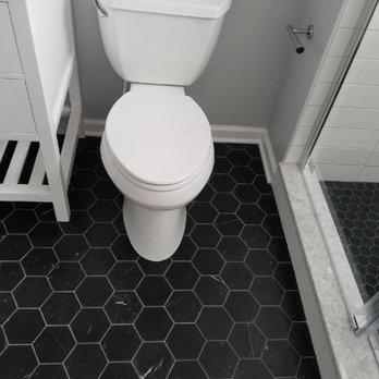 JT Custom Builders - a white toilet in a bathroom - General Contractors Near Me JT Custom Builders - a white toilet in a bathroom - General Contractors Near Me