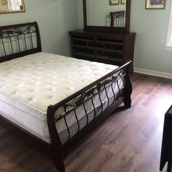 Romanoff Renovations - a bedroom with a bed, dresser and mirror - Flooring Near Me - Memphis, Tennessee Romanoff Renovations - a bedroom with a bed, dresser and mirror - Flooring Near Me - Memphis, Tennessee