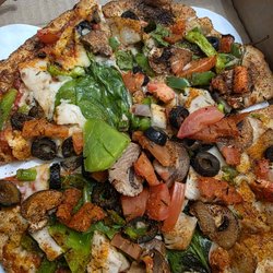 Guido's Premium Pizza Grand Blanc - A baby veggie thin crust with Cajun seasoning and chicken.