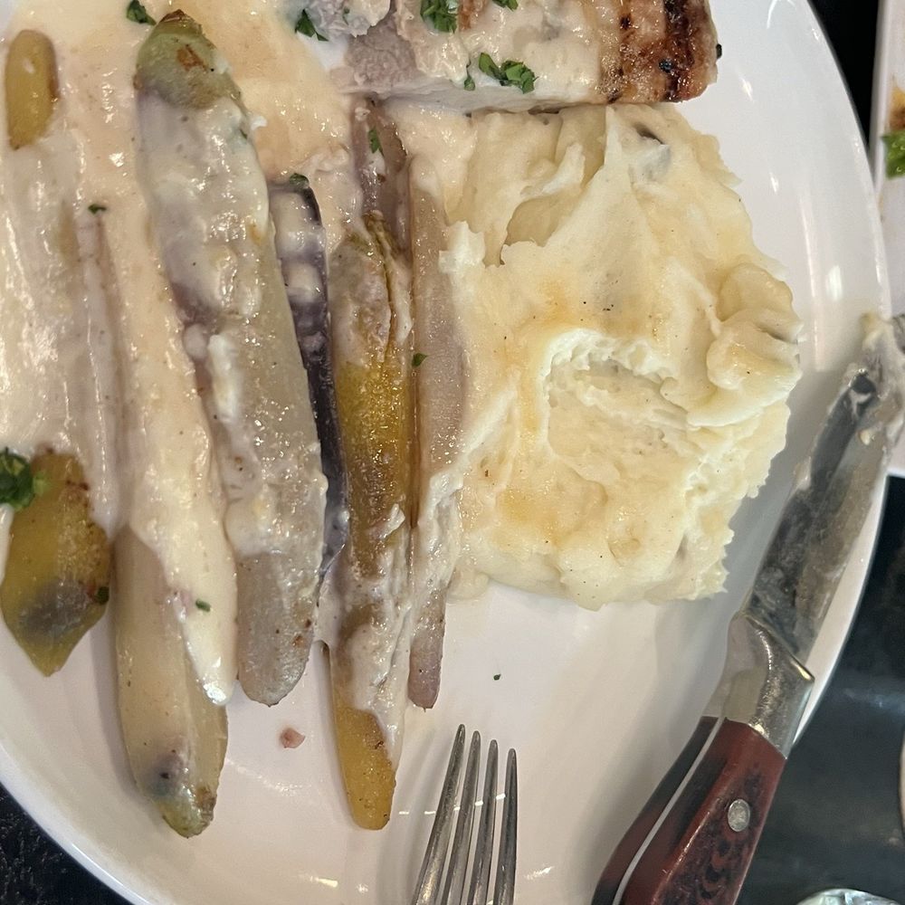 Americana - Tomahawk pork chop - split with my friend across the table - New American Near Me - Des Moines, Iowa Americana - Tomahawk pork chop - split with my friend across the table - New American Near Me - Des Moines, Iowa