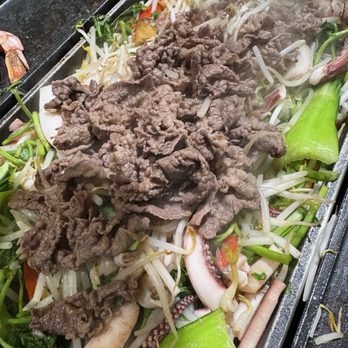 Chungchoon Sikdang - Stir frying the brisket with veggies and seafood on the pan - Korean Near Me - Fort Lee, New Jersey Chungchoon Sikdang - Stir frying the brisket with veggies and seafood on the pan - Korean Near Me - Fort Lee, New Jersey