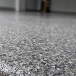 Garage Rehab - Sea Mist epoxy flake coating with polyaspartic top coat by Garage Rehab Central Florida