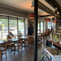 Maplewood Deli & Coffeehouse - Maplewood Coffee Grounds front seating area with white deep freeze ice cream chest. Memorial Day 2024