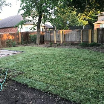 Freedom Lawn Services -  backyard with a lawn and fence - Lawn Services Near Me