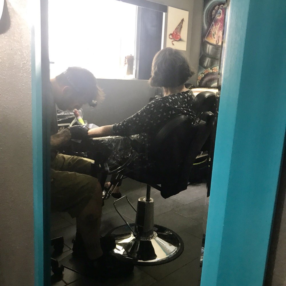 Triton Tattoo - Reflection of Ross working on my mom's tattoo - Tattoo Near Me - Santa Cruz, California