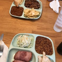 a plate of baked beans, ham, beans, and a sandwich a plate of baked beans, ham, beans, and a sandwich