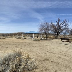 Covered picnic area near the grass.