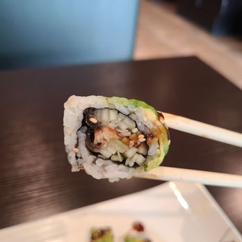 Sushi Palace - chopsticks holding a piece of sushi - Japanese Near Me - Yonkers, New York Sushi Palace - chopsticks holding a piece of sushi - Japanese Near Me - Yonkers, New York