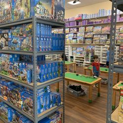 Play Well Marin Activity Center - The play area with 6 tables. Surrounded by every Lego set.