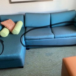Worn out couch with stains, fraying and sagging cushions. Worn out couch with stains, fraying and sagging cushions.