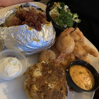 Miller's Waterfront Restaurant - Crab cake with shrimp, broccoli salad and baked potato - Seafood Near Me - Nags Head, North Carolina Miller's Waterfront Restaurant - Crab cake with shrimp, broccoli salad and baked potato - Seafood Near Me - Nags Head, North Carolina