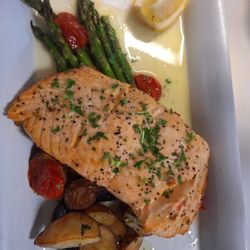 Blistered green beans and grape tomatoes with roasted red potatoes baked salmon with a lemon butter and parsley.