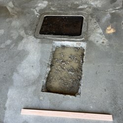 Advance Plumbing - Filling back the hole and preparing to patch up the concrete.