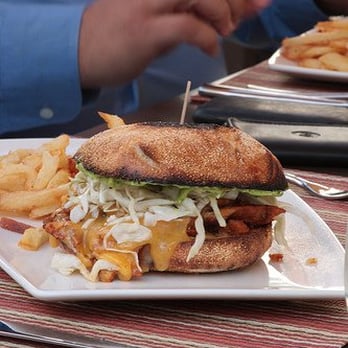 Wine Cask - House-smoked chicken sandwich, Sundeen's BBQ Sauce, citrus marinated cabbage, cilantro-lime aioli, fries or greens. $11. - New American Near Me - Santa Barbara, California
