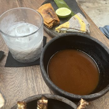 Negro Huitlacoxe - Back: Birria Taco and Quesadilla Natural Middle: horchata maize, Birria juices for dipping taco Front: dorado maize - Mexican Near Me - Tulum, ROO