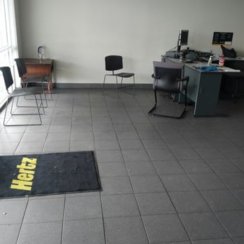 Hertz Rent A Car - Lobby.  The chairs were dirty, empty 1gallon water bottle sitting on what looked like an old broken night stand. - Car Rental Near Me - Goodyear, Arizona