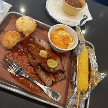 Jim 'N Nick's Bar-B-Q - Marble brisket, mac n cheese, bake beans, and barbeque corn on the cob. - Barbeque Near Me - Warner Robins, Georgia