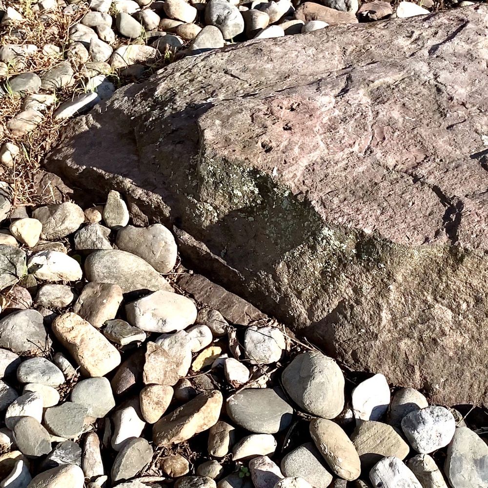 SLS Landscaping - a large rock laying on a bed of rocks - Landscaping Near Me - Lumberton, New Jersey