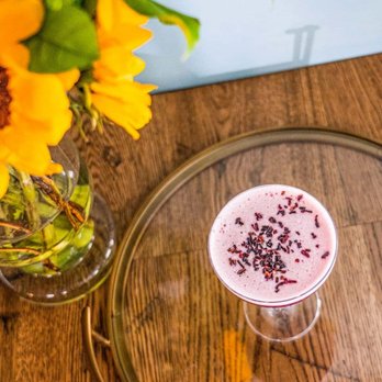 The Vintage at Millbrook - a glass of milk and a vase of sunflowers - New American Near Me - Millbrook, New York