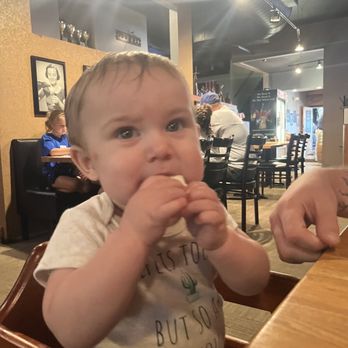 Oaken Barrel Brewing - Baby in high chair and a glimpse of the indoor decor - Breweries Near Me - Greenwood, Indiana Oaken Barrel Brewing - Baby in high chair and a glimpse of the indoor decor - Breweries Near Me - Greenwood, Indiana