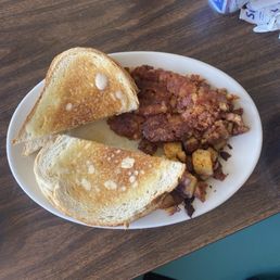 Sour dough toast with two over fried eggs with a heaping portion of Corn Beef Hash with hash browns. Delicious