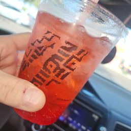 a person holding a drink in their hand