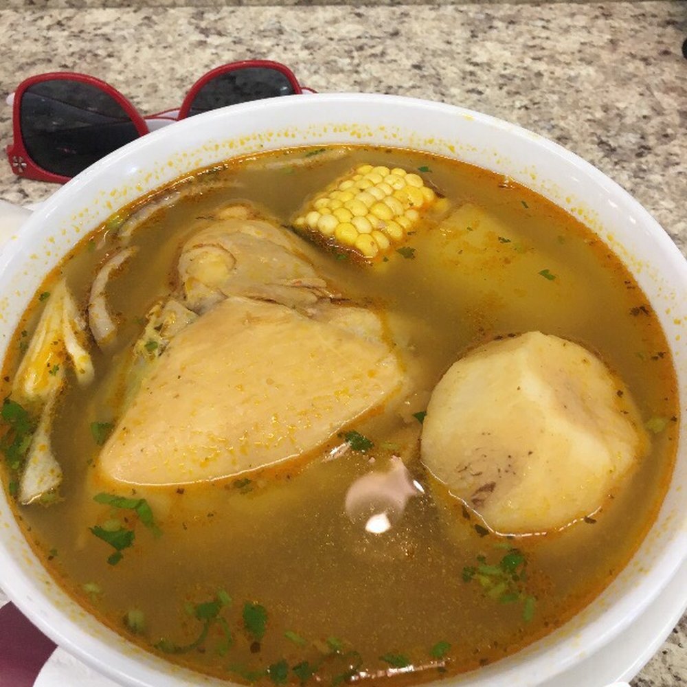 Arepera La Nueva - Chicken soup w/malanga, yuca, & corn. Sunglasses in background for reference. 5/11/17 - Latin American Near Me - Orlando, Florida Arepera La Nueva - Chicken soup w/malanga, yuca, & corn. Sunglasses in background for reference. 5/11/17 - Latin American Near Me - Orlando, Florida