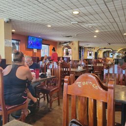 people sitting at tables in a restaurant people sitting at tables in a restaurant
