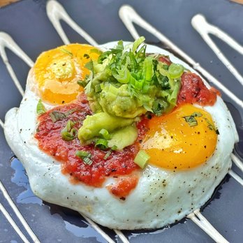 King Taps - a fried egg topped with tomatoes and avocado - Canadian (New) Near Me - Toronto, Ontario