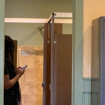 Another Broken Egg Cafe - Waitress in bathroom with apron on. - Breakfast & Brunch Near Me - Dunwoody, Georgia
